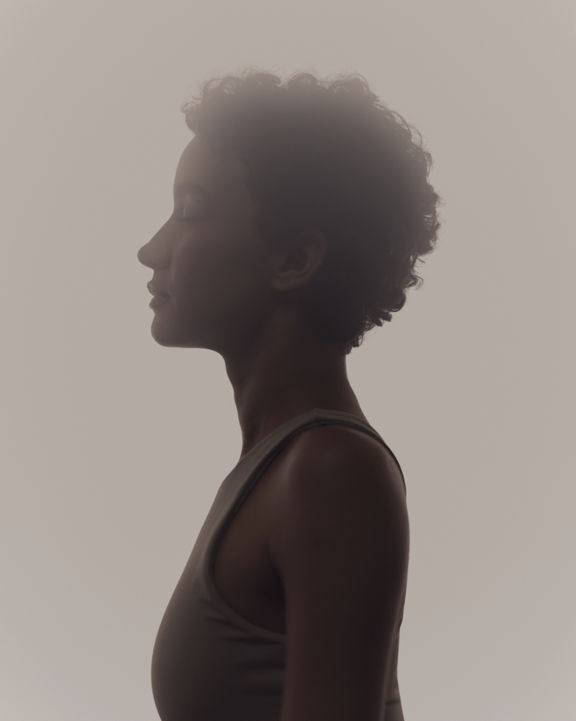 Stylized profile of a woman in a surrender yoga class at Life Time