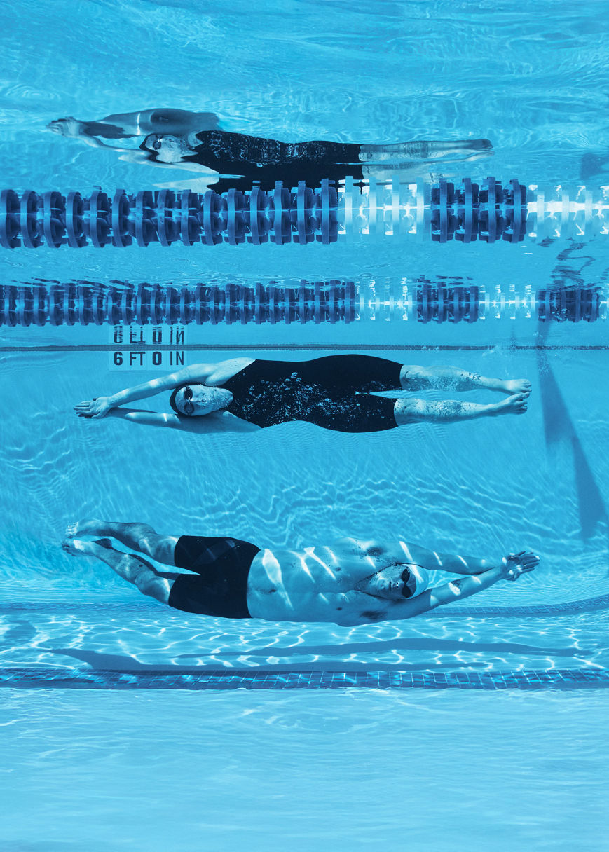 3 swimmers doing a dolphin kick underwater