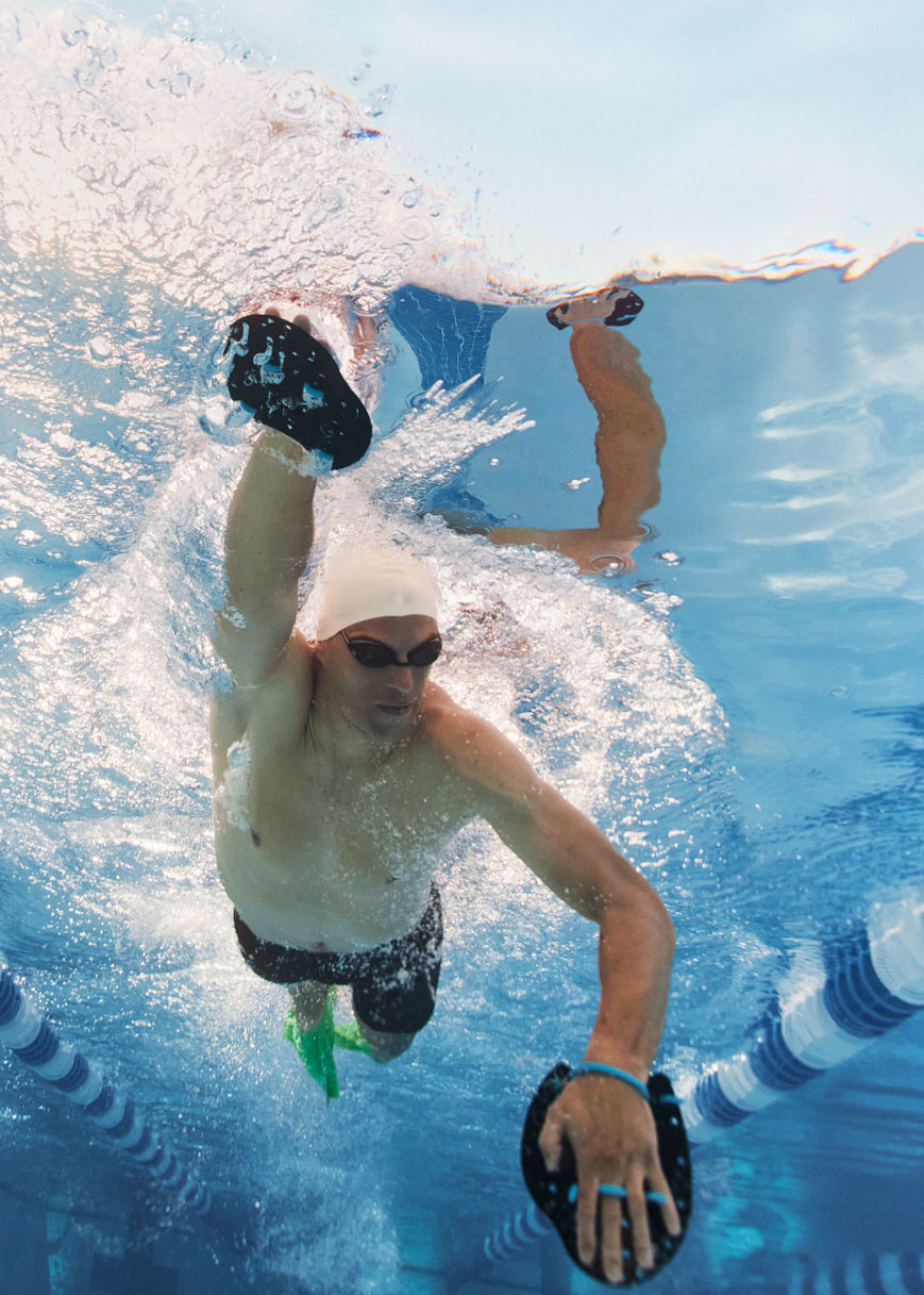 man swimming underwater in a pool