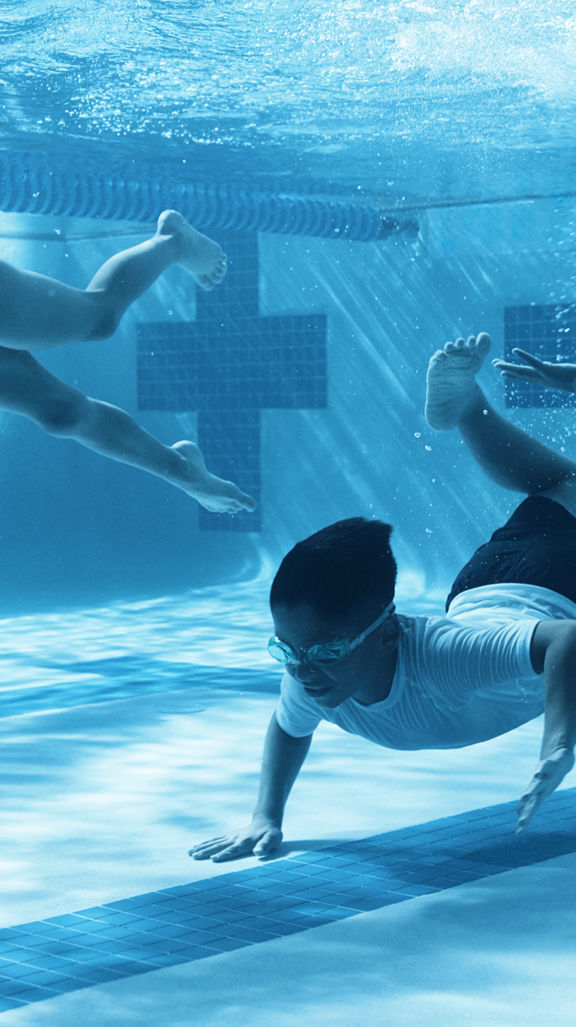 three kids swimming under water