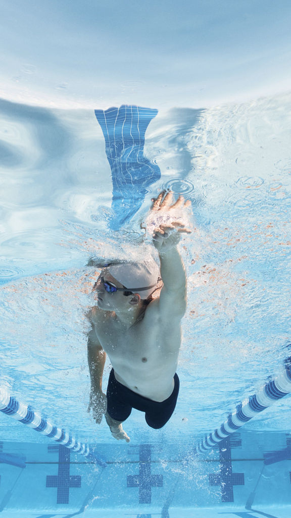 man doing swimming in a lap pool