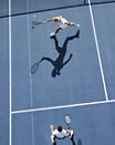 Aerial view of two people playing tennis on an outdoor tennis court