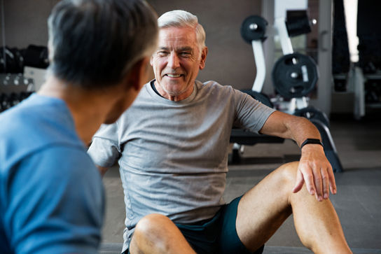 Male participants talking during a group training session