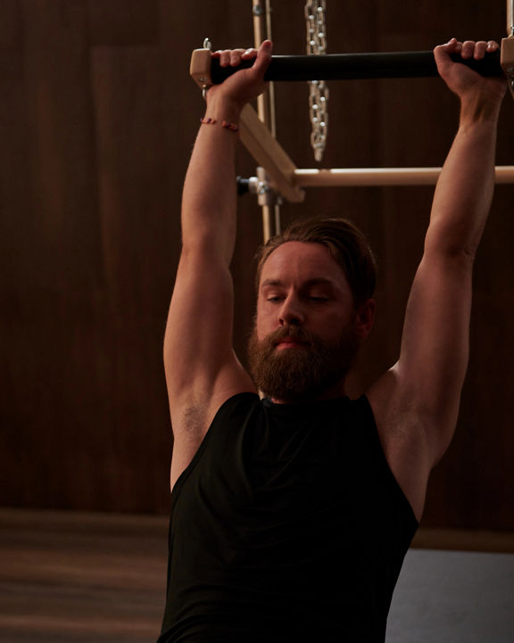 A man stretching in a pilates class