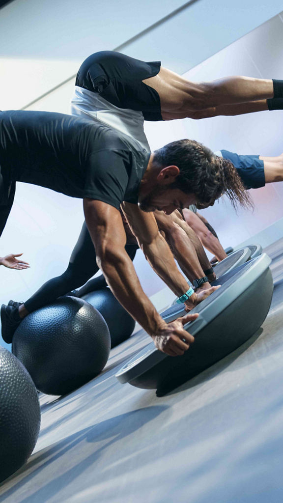 Class using bosu balls and yoga balls in an UltraFit boutique group training class