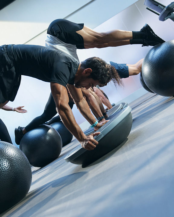 Class using bosu balls and yoga balls in an UltraFit boutique group training class