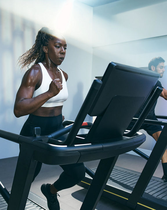 Person sprinting on a treadmill in the UltraFit boutique group training class