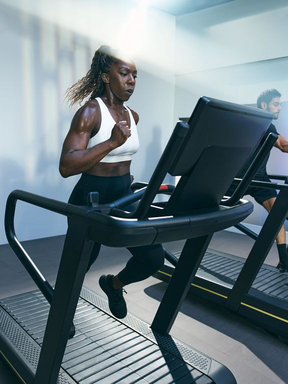 Person sprinting on a treadmill in the UltraFit boutique group training class