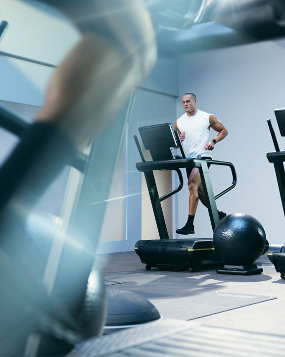 Person running on a treadmill in the UltraFit boutique group training class