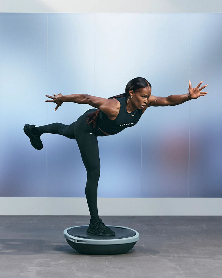 a woman in a bosu heisman pose