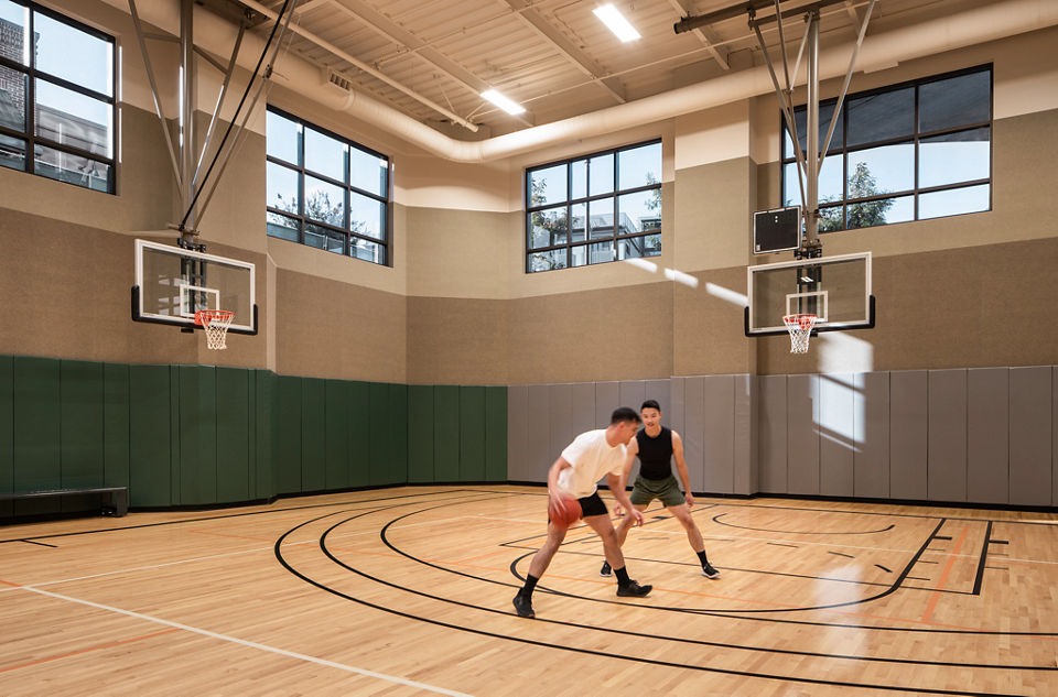 Two Life Time members playing basketball in the gymnasium at the Life Time Walnut Creek club location
