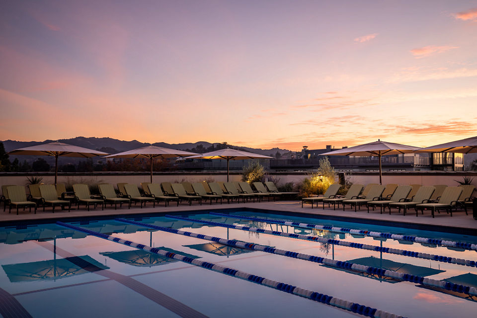 Outdoor lap pool at the Life Time Walnut Creek club location at dusk