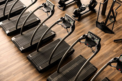 line of treadmills on a workout floor