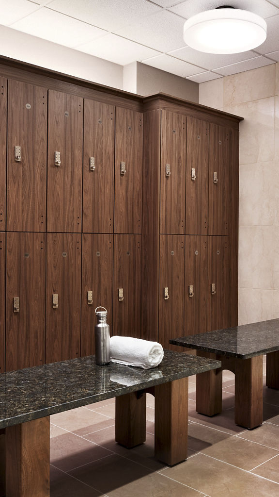 Bay of lockers and shower stalls in a locker room at Life Time