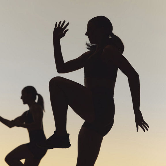 Two Life Time Xtreme cardio class members in silhouette