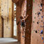 A man climbing and indoor climbing wall