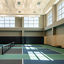 3 indoor pickleball courts in a brightly lit gymnasium