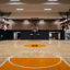 An indoor basketball court and gymnasium in New York with Uhoops branding