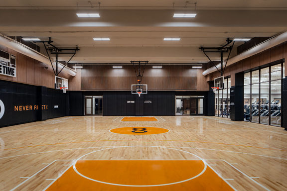 An indoor basketball court and gymnasium in New York with Uhoops branding