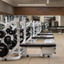Weight benches and free weights on the fitness floor at Life Time