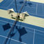 Aerial view of outdoor tennis courts with benches and umbrellas at our Folsom, California club location.