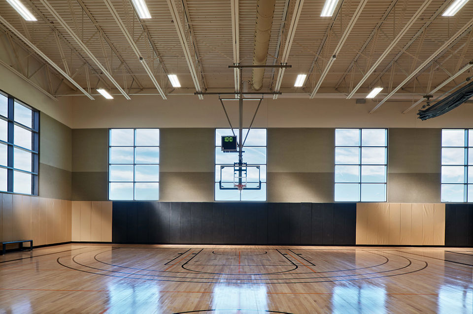 Gleaming, well-lit basketball court and gymnasium