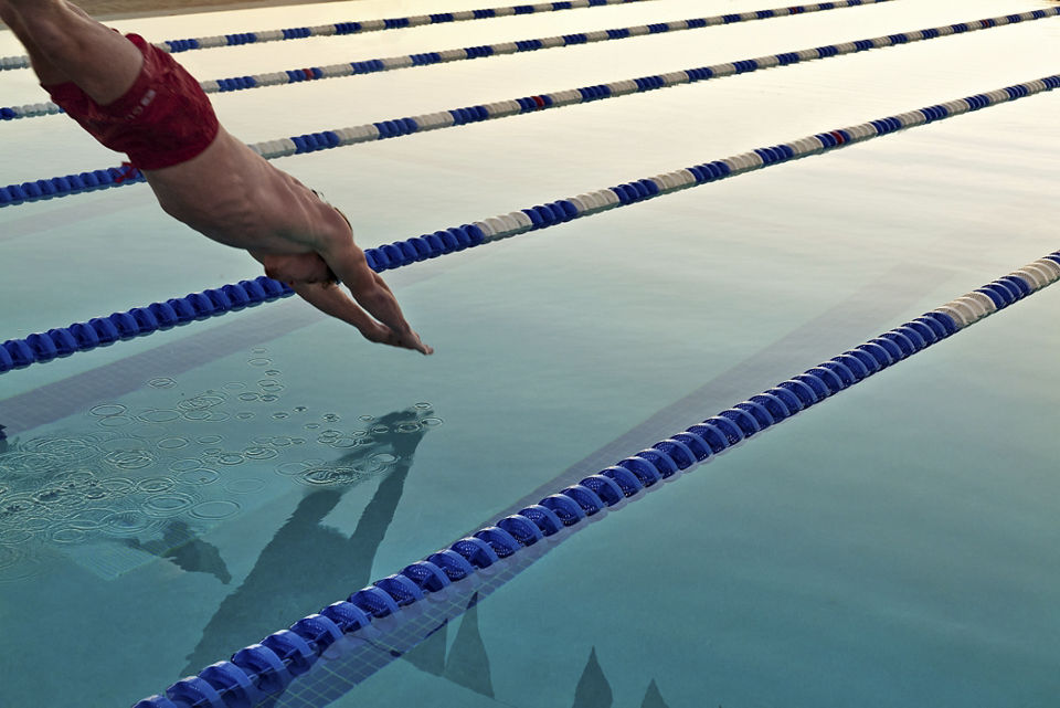 A man dives into a lap pool