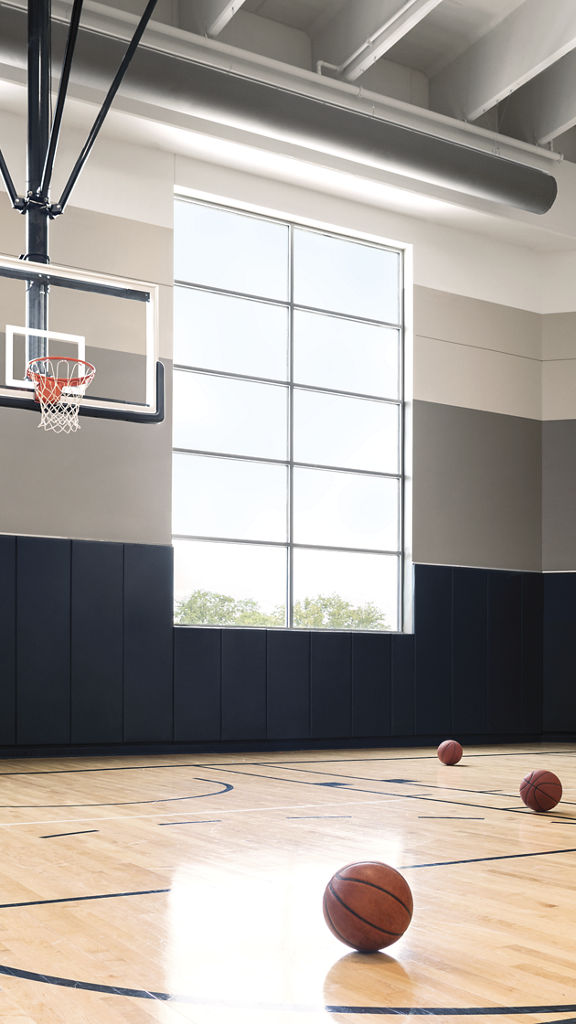 Basketball court with basketballs scattered on the floor