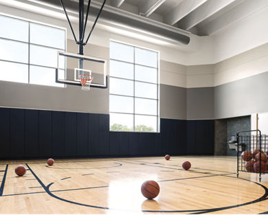 Basketball court with basketballs scattered on the floor