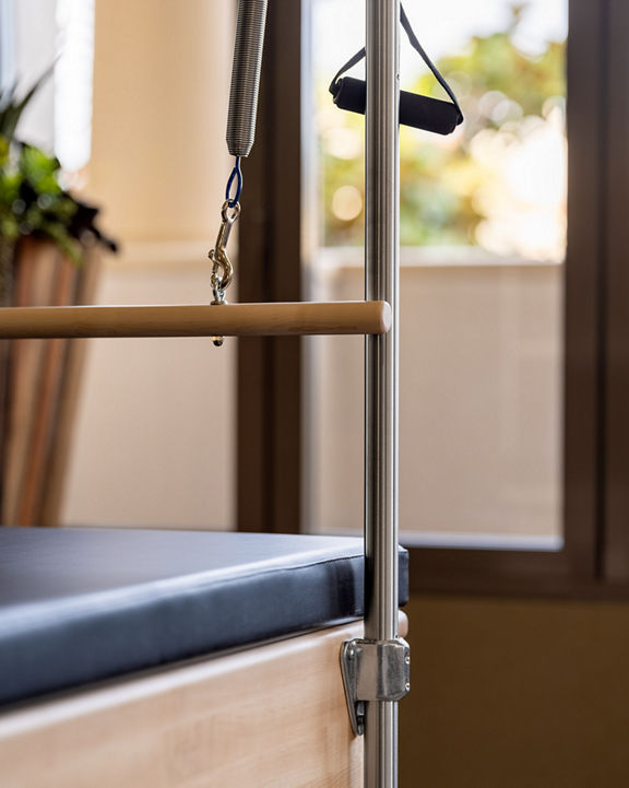 Close-up of a Pilates reformer machine.