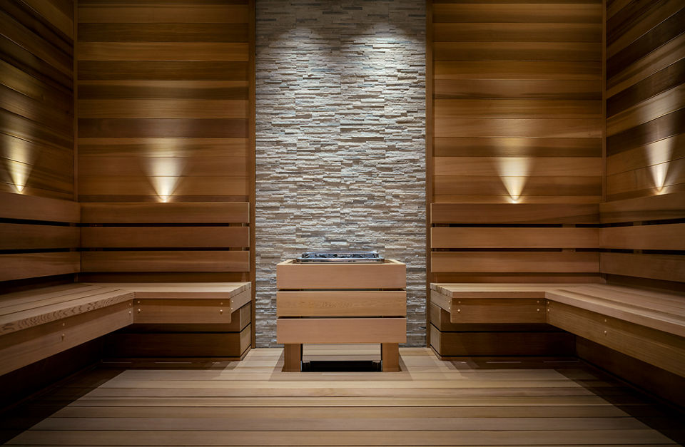 A warm wood and stone sauna interior