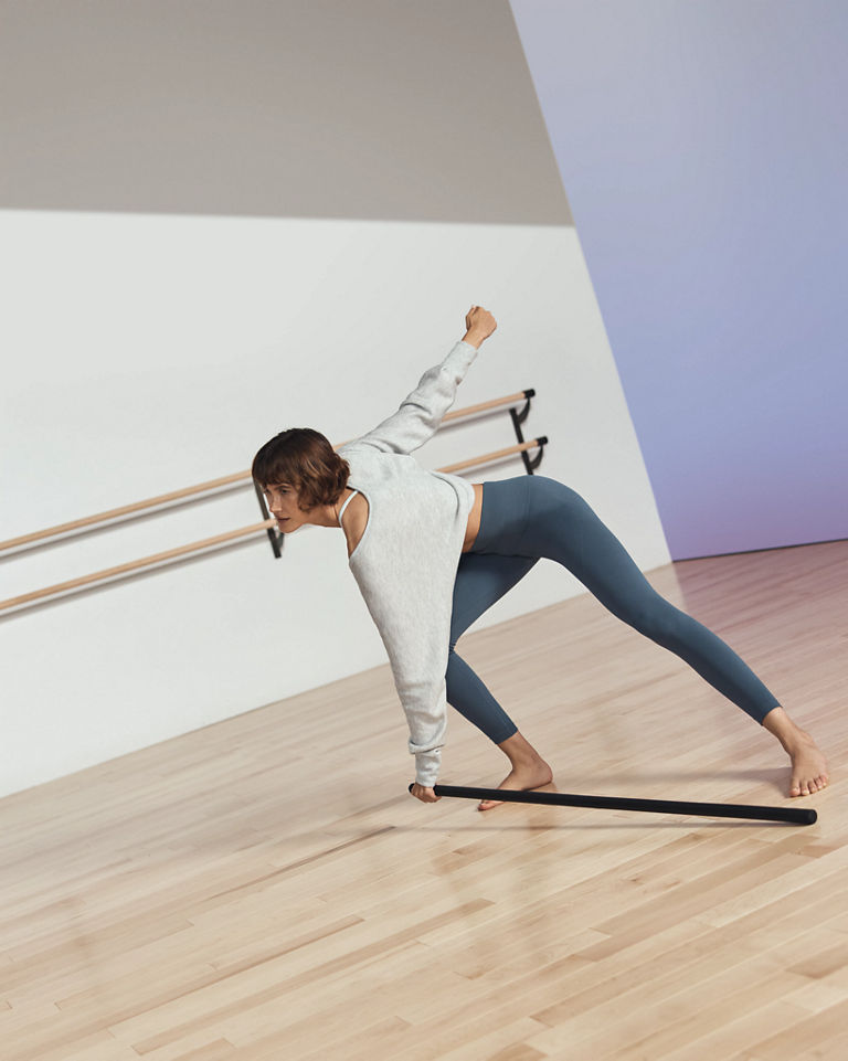 Life barre participant in forward bend position with body bar