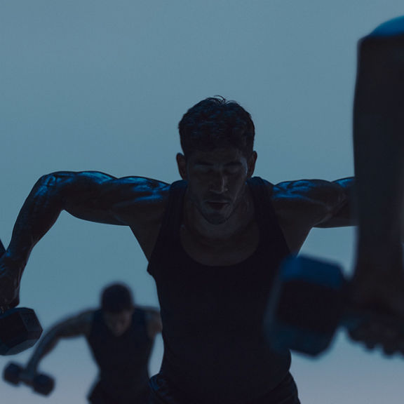Maxout strength class featuring a group of people working out with barbells