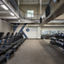 A row of treadmills, kettlebells, and medicine balls in a GTX training area