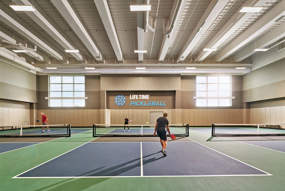 Two adults playing a game of pickleball