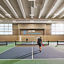 Two adults playing a game of pickleball