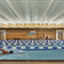 An adult male swimming laps in an indoor lap pool