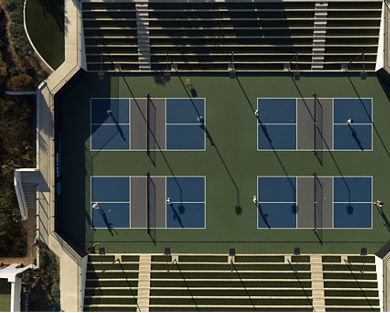 An aerial view of Life Time members playing on four outdoor pickleball courts