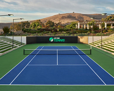 Outdoor tennis court with stadium seating at the Rancho San Clemente Life Time club