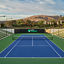 Outdoor tennis court with stadium seating at the Rancho San Clemente Life Time club