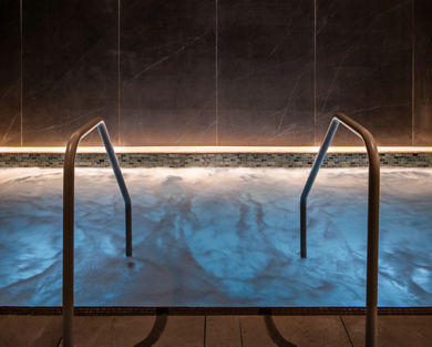 stairs leading into a dimly lit, bubbling whirlpool