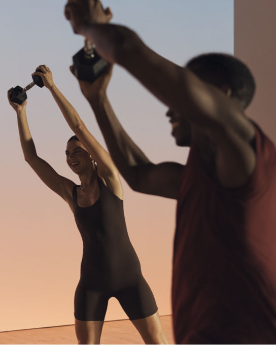 Two members lifting a barbell overhead in a Shred strength class
