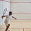 A male and female couple playing a game of squash