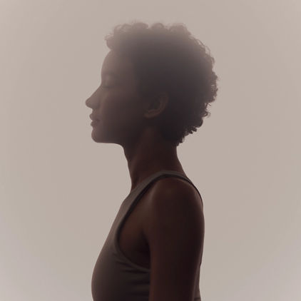 Stylized profile of a woman in a surrender yoga class at Life Time
