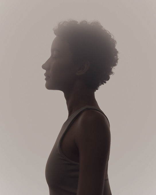 Stylized profile of a woman in a surrender yoga class at Life Time