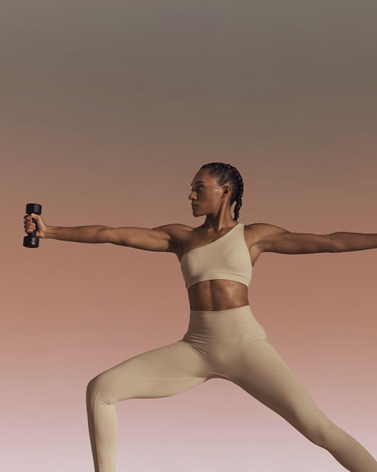 Life Time member using hand weights in warrior sculpt yoga class