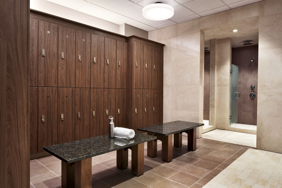 Bay of lockers and shower stalls in a locker room at Life Time