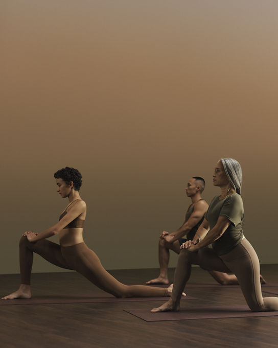 Yogis in low lunge pose during a yoga class at Life Time